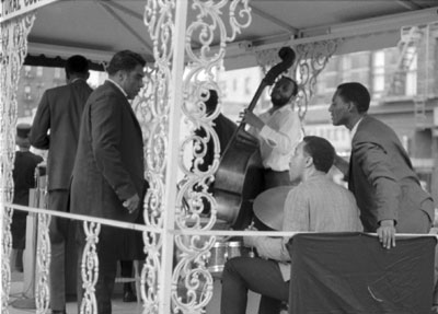  From left: John Gilmore (with back to camera), unknown, Don Moore on bass, Billy Higgins on drums, unknown on right.